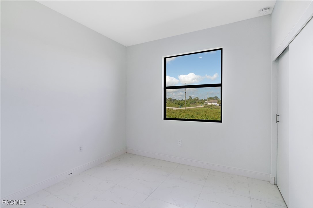 9018 West Castle Circle LaBelle, FL 33935 - Photo 14 of 27 an empty room with window and wall painting