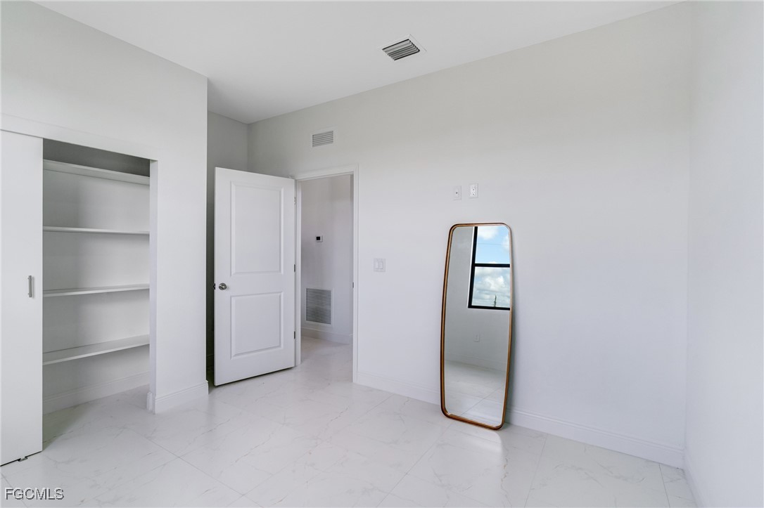 9018 West Castle Circle LaBelle, FL 33935 - Photo 15 of 27 a room with a door and closet