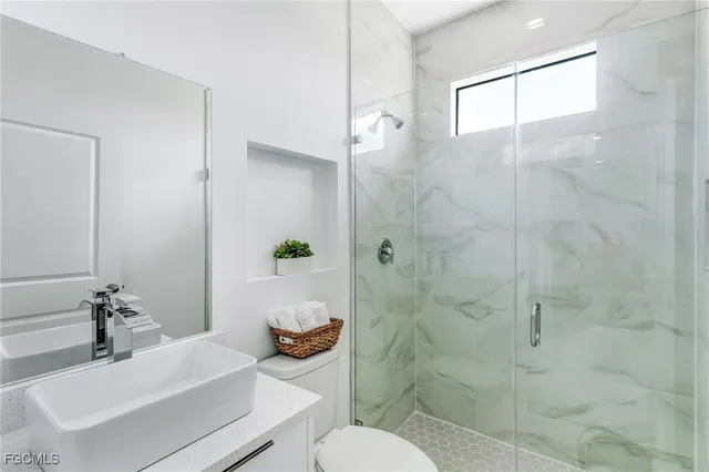 a bathroom with a sink toilet and shower