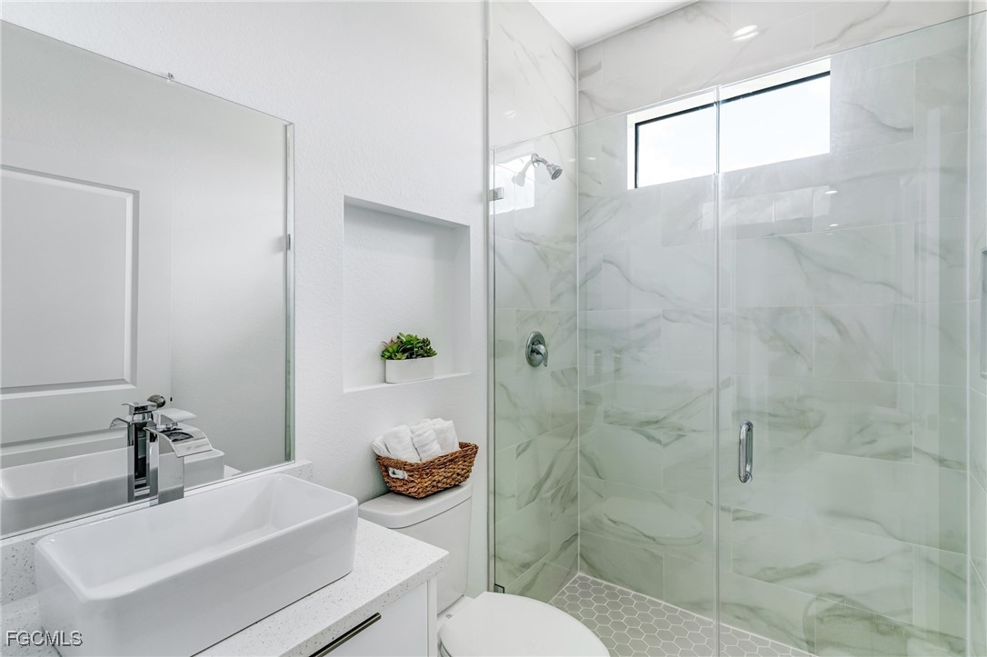 9018 West Castle Circle LaBelle, FL 33935 - Photo 16 of 27 a bathroom with a sink toilet and shower