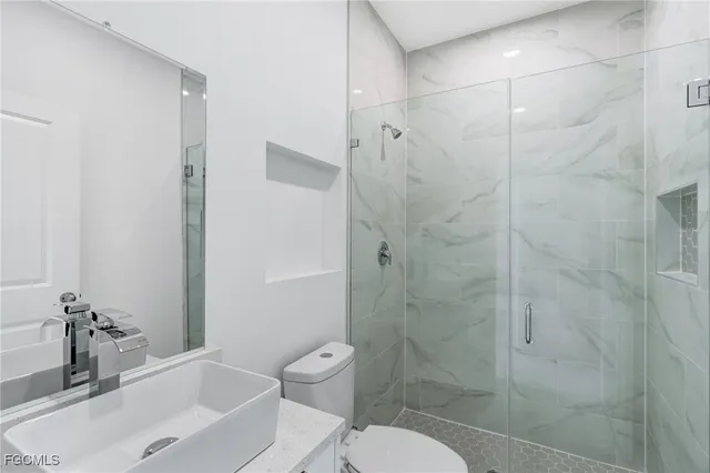 a bathroom with a shower and a toilet