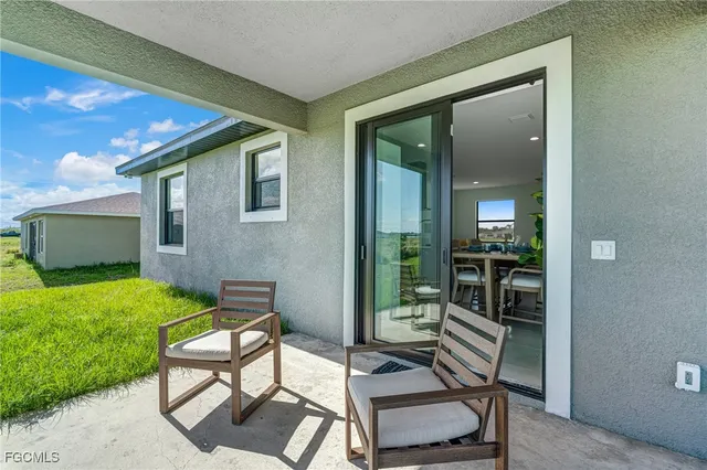 a balcony with furniture and a yard