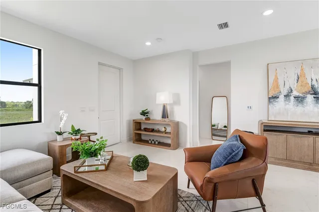 a living room with furniture and a potted plant