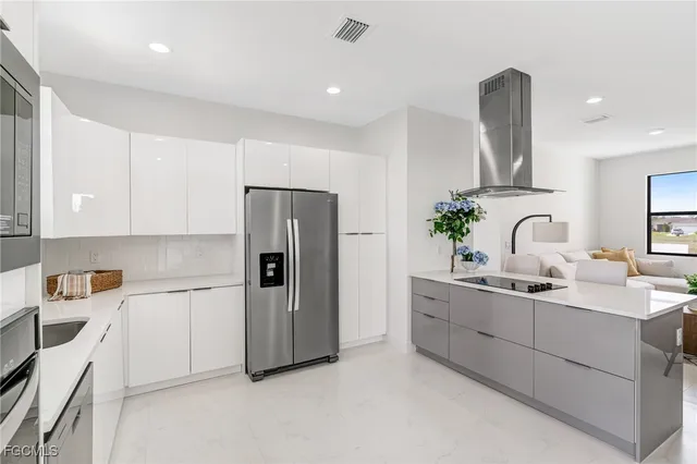 a kitchen with refrigerator and cabinets