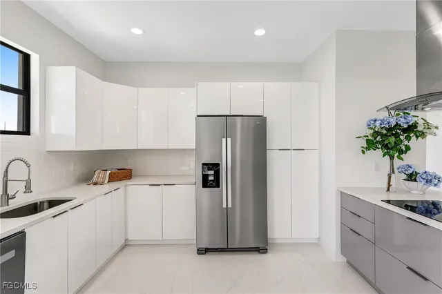 a kitchen with white cabinets and refrigerator