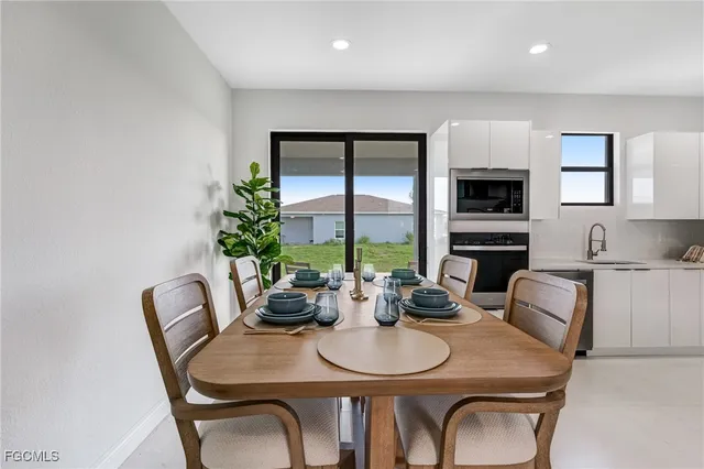 a dining room with furniture a window and a kitchen view