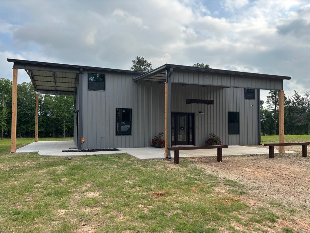 207 George Wilson Road Huntsville, TX 77320 - Photo 1 of 26 a view of a house with backyard and porch