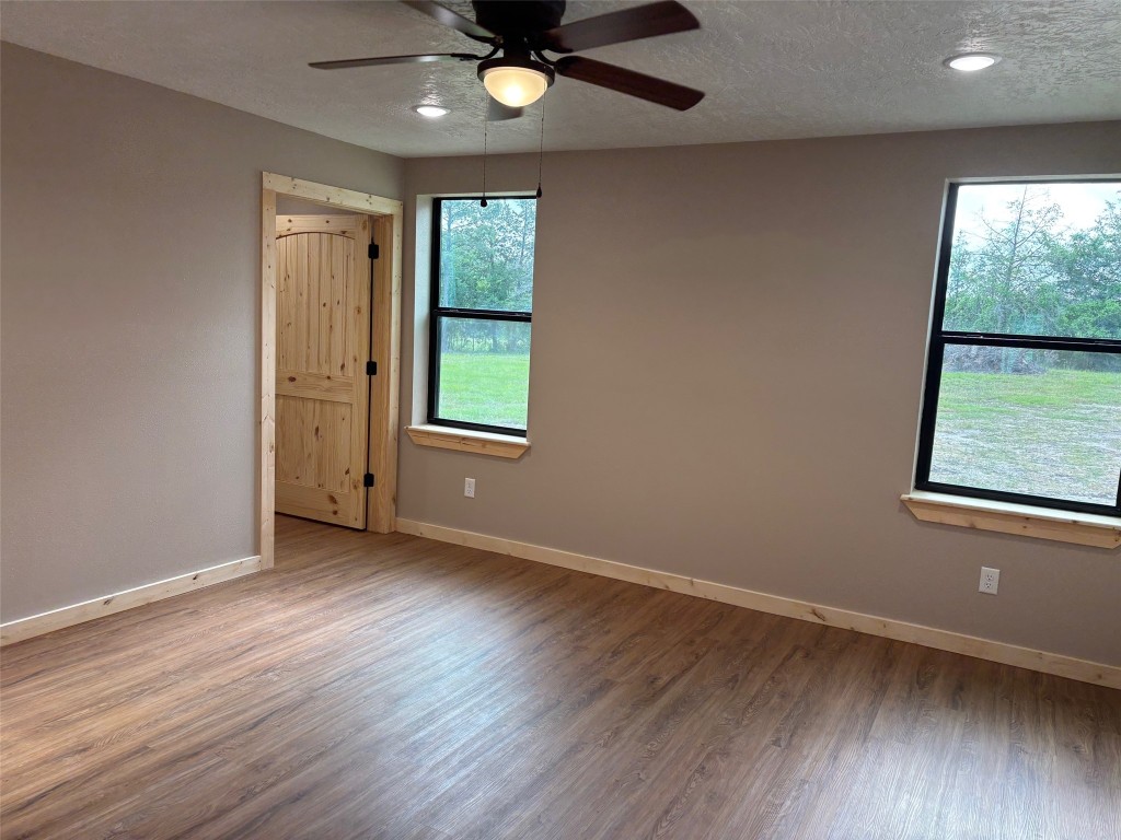 207 George Wilson Road Huntsville, TX 77320 - Photo 14 of 26 wooden floor in an empty room with a window