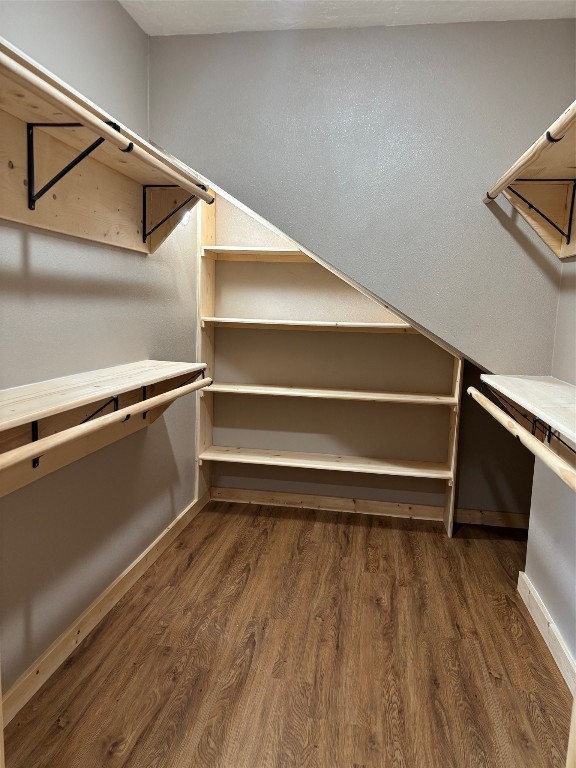 207 George Wilson Road Huntsville, TX 77320 - Photo 19 of 26 a view of an empty room with wooden floor and a window