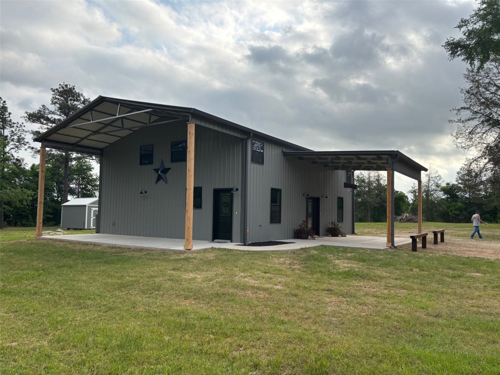 207 George Wilson Road Huntsville, TX 77320 - Photo 2 of 26 a view of a house with a yard