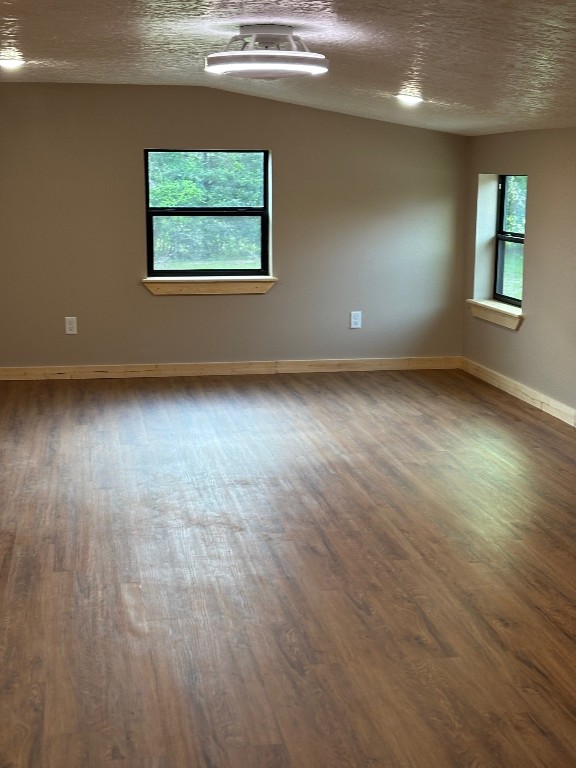 207 George Wilson Road Huntsville, TX 77320 - Photo 24 of 26 an empty room with wooden floor and windows