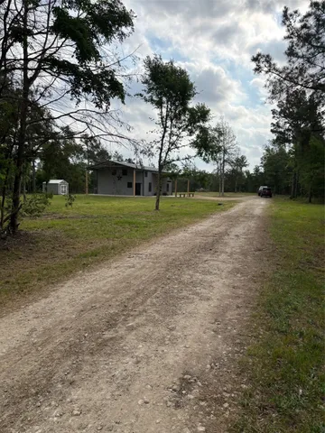 a view of a field of grass and trees