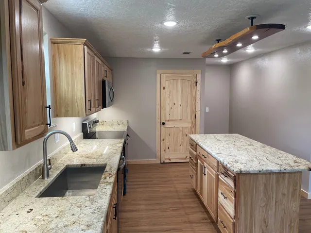 a kitchen with a sink and a refrigerator