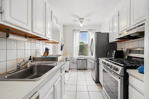 a kitchen with a sink a stove and refrigerator