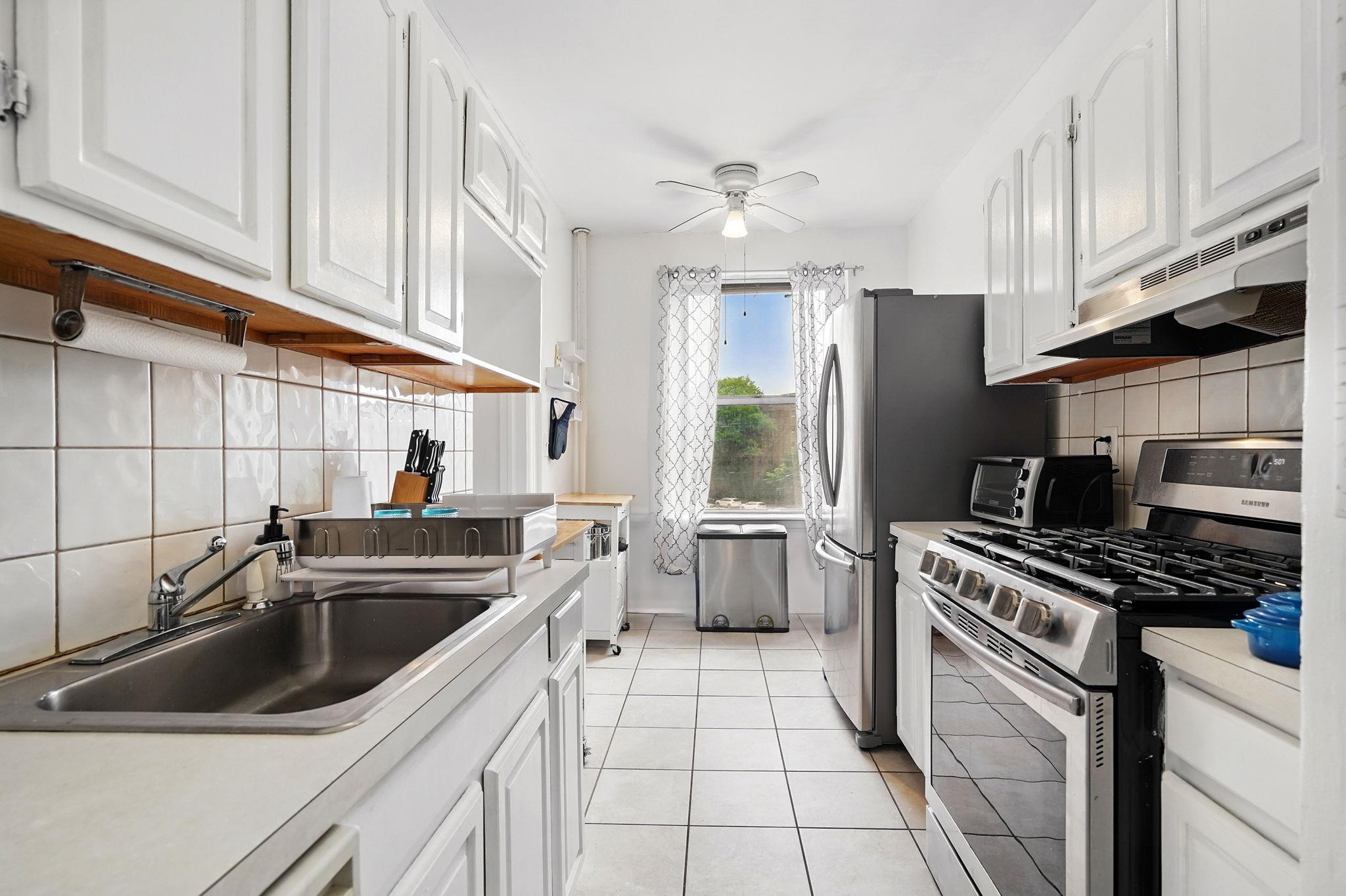 472 Gramatan Avenue, Unit CC3 Mount Vernon, NY 10552 - Photo 9 of 25 a kitchen with a sink a stove and refrigerator