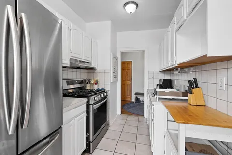 a kitchen with stainless steel appliances a refrigerator sink and stove