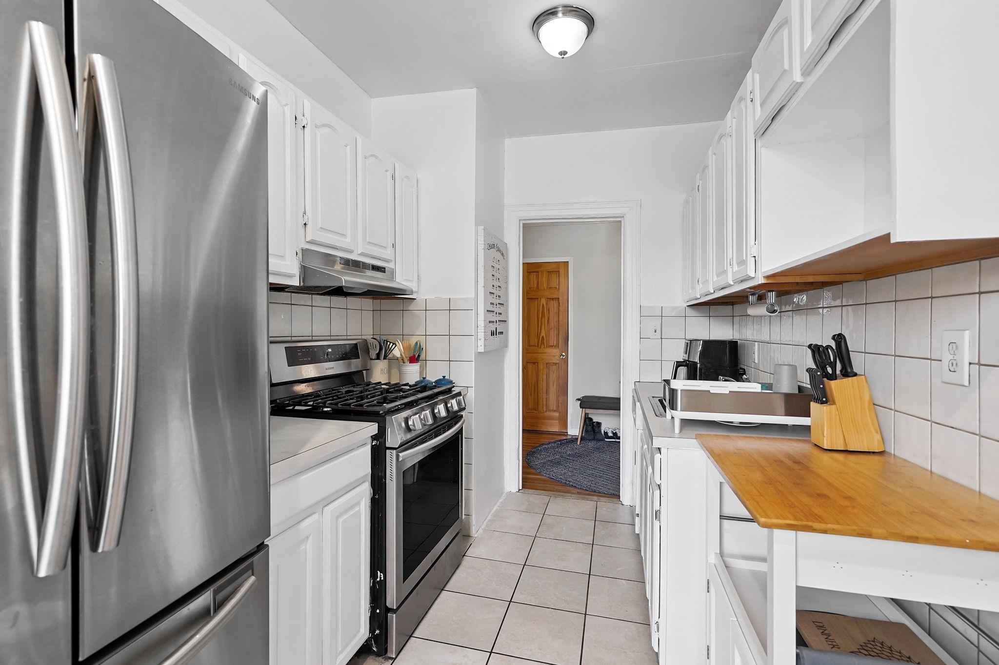 472 Gramatan Avenue, Unit CC3 Mount Vernon, NY 10552 - Photo 10 of 25 a kitchen with stainless steel appliances a refrigerator sink and stove