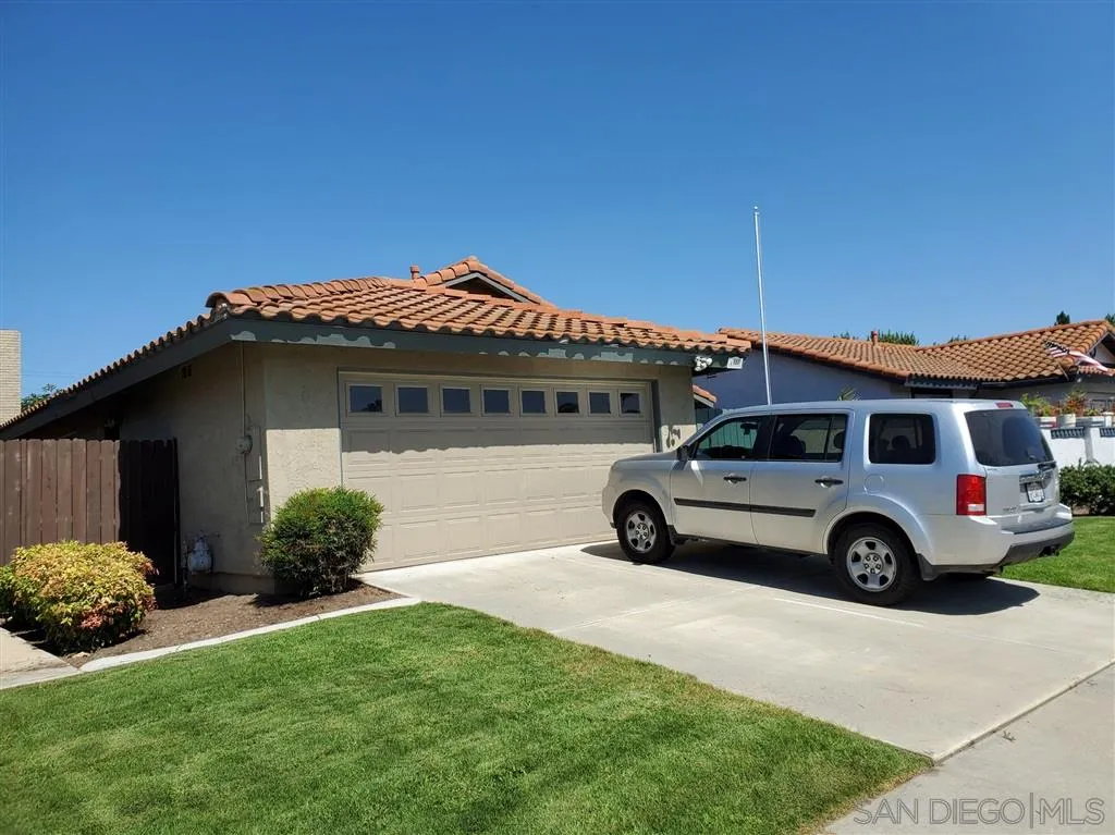 4876 Sumac Place Oceanside, CA 92057 - Photo 1 of 14 a blue house with trees in front of it