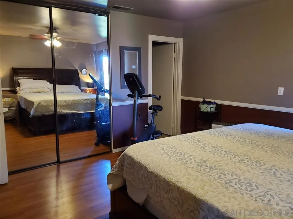 4876 Sumac Place Oceanside, CA 92057 - Photo 11 of 14 a bedroom with a bed and a ceiling fan