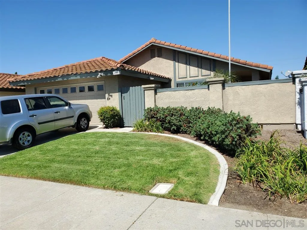 4876 Sumac Place Oceanside, CA 92057 - Photo 2 of 14 a front view of a house with garden