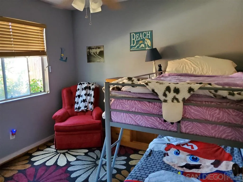 4876 Sumac Place Oceanside, CA 92057 - Photo 9 of 14 a bedroom with a bed and a table