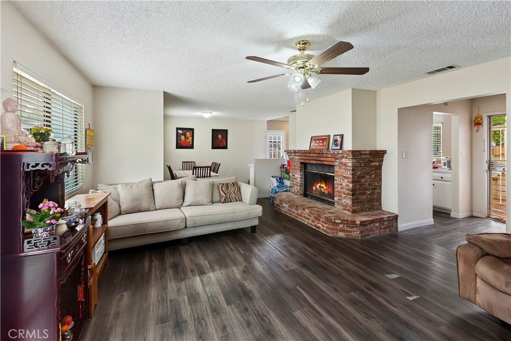 8085 Garfield Street Riverside, CA 92504 - Photo 1 of 1 a living room with furniture and a fireplace