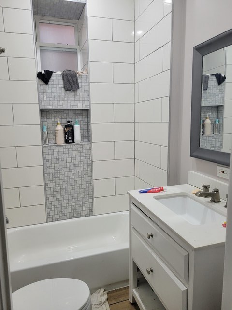 6016 South Carpenter Street Chicago, IL 60621 - Photo 4 of 15 a bathroom with a bathtub shower sink vanity and toilet