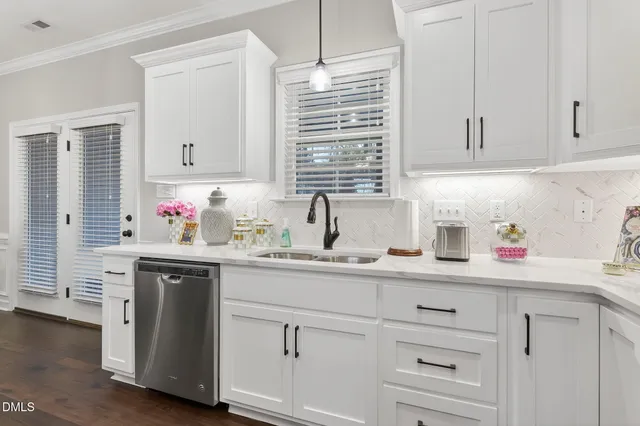 a kitchen with white cabinets and white appliances