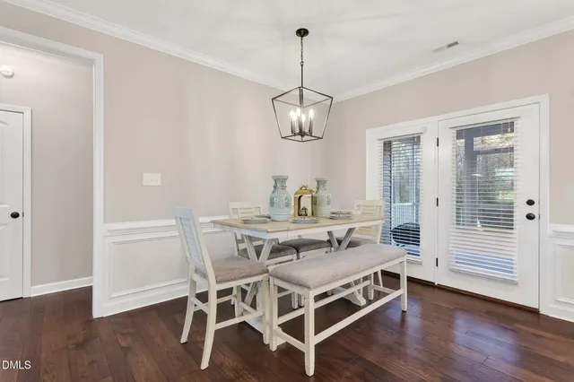a view of a dining room with furniture wooden floor and chandelier