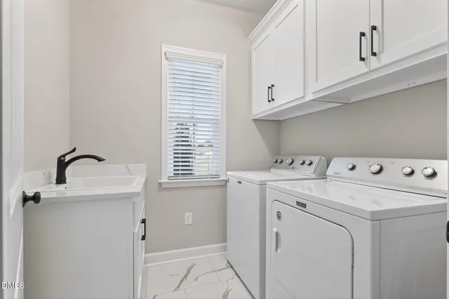 a living room with a window and a ceiling fan