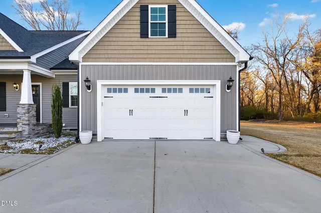 a view of a house with a yard and garage