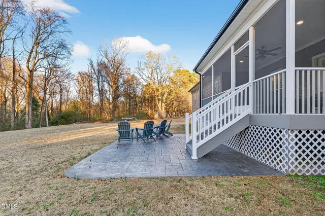 a front view of a house with a yard and ocean view