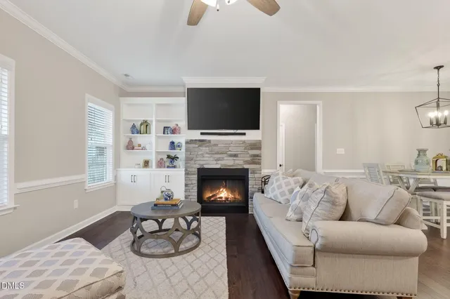 a living room with furniture fireplace and window