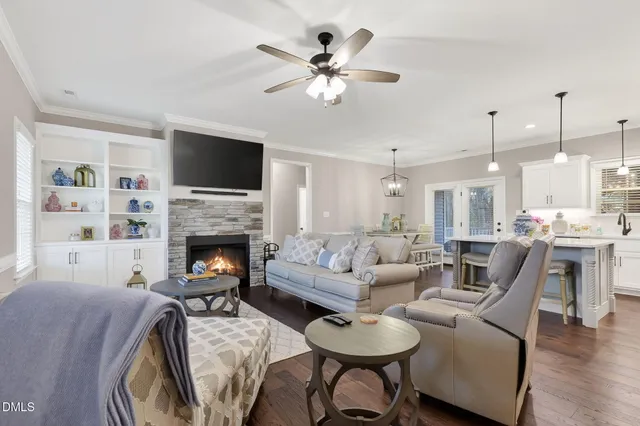 a living room with furniture a fireplace and a flat screen tv