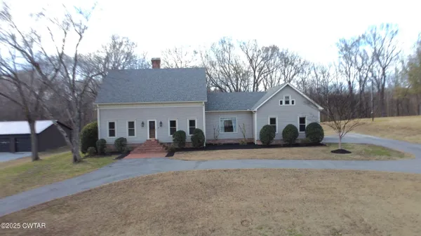 a view of a house with a yard covered in snow