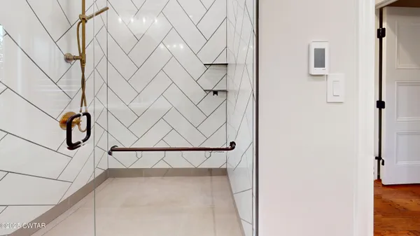 a view of empty room with fireplace and fan