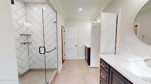 an empty room with a window and a ceiling fan