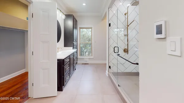 a white toilet sitting next to a white cabinet