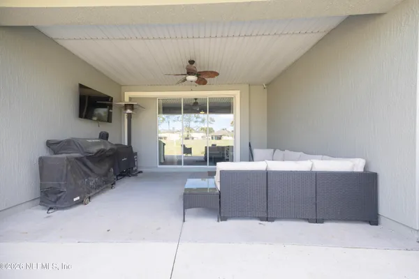 a view of a swimming pool with a table and chairs under an umbrella