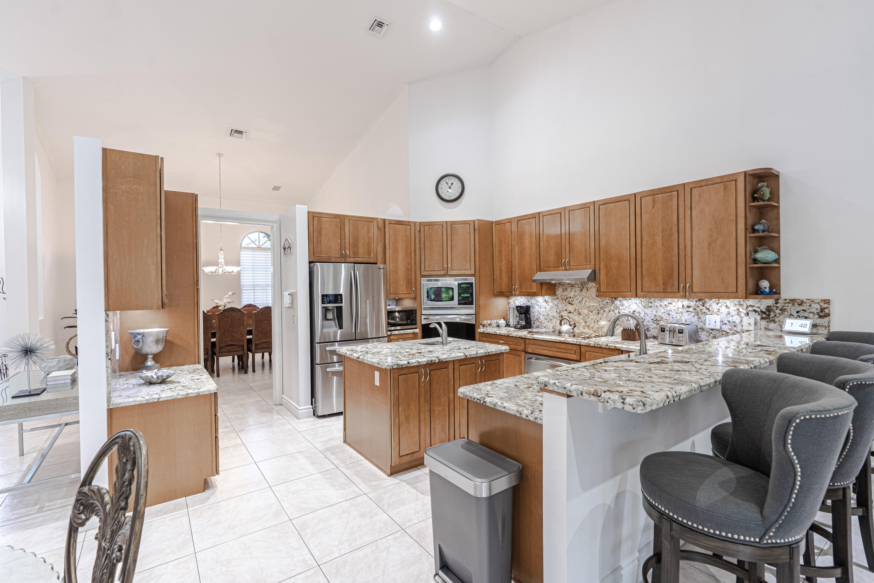 15350 Take Off Place Wellington, FL 33414 - Photo 11 of 44 a kitchen with a refrigerator a stove a sink dishwasher with a dining table and chairs