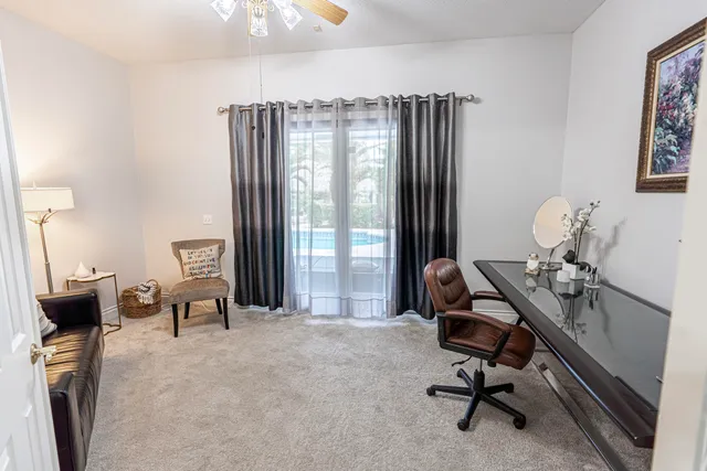 a view of a workspace with furniture and a window