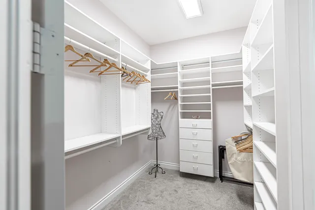 a view of walk in closet with empty racks