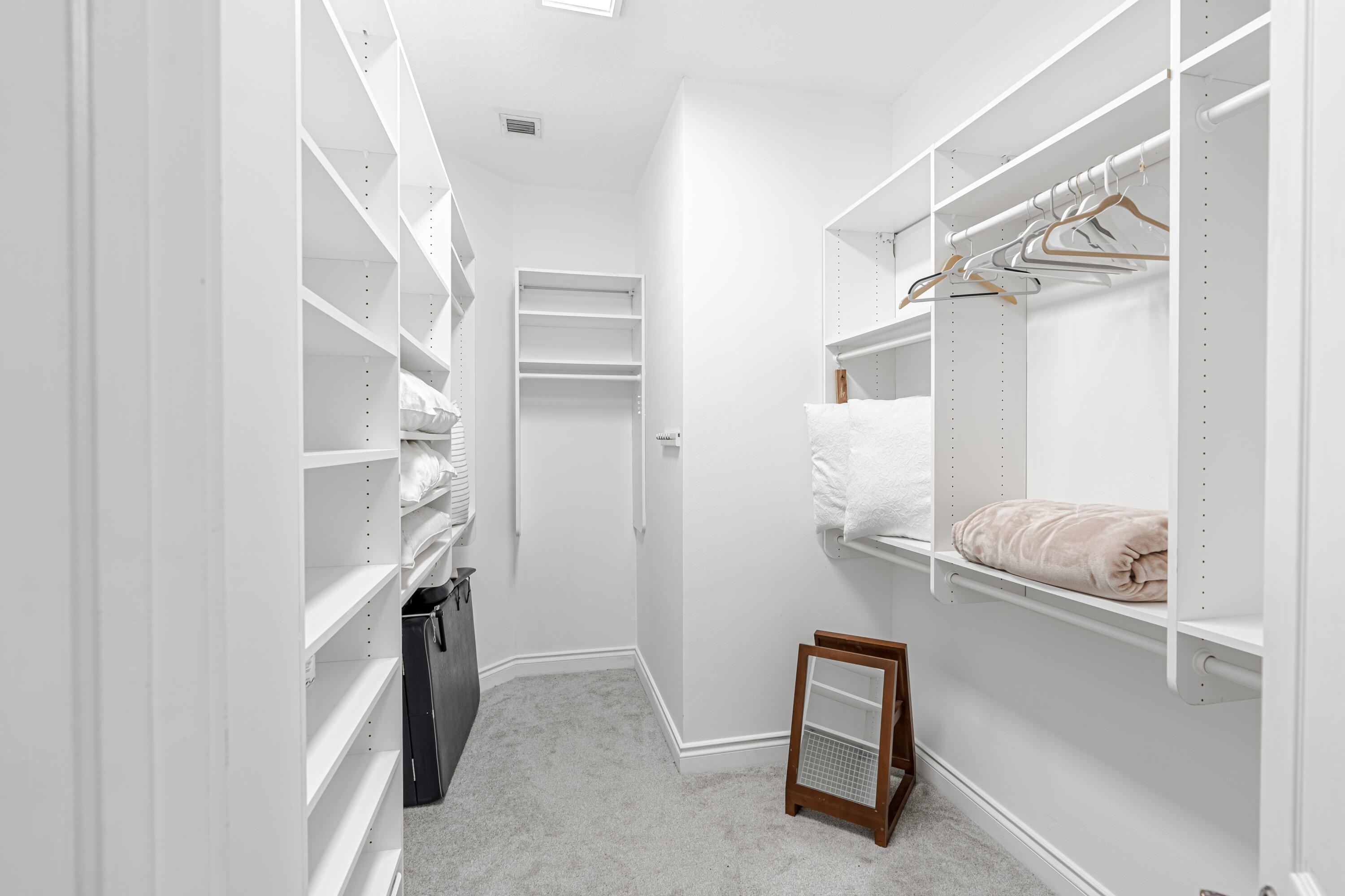 15350 Take Off Place Wellington, FL 33414 - Photo 20 of 44 a view of walk in closet with clothes and shoes