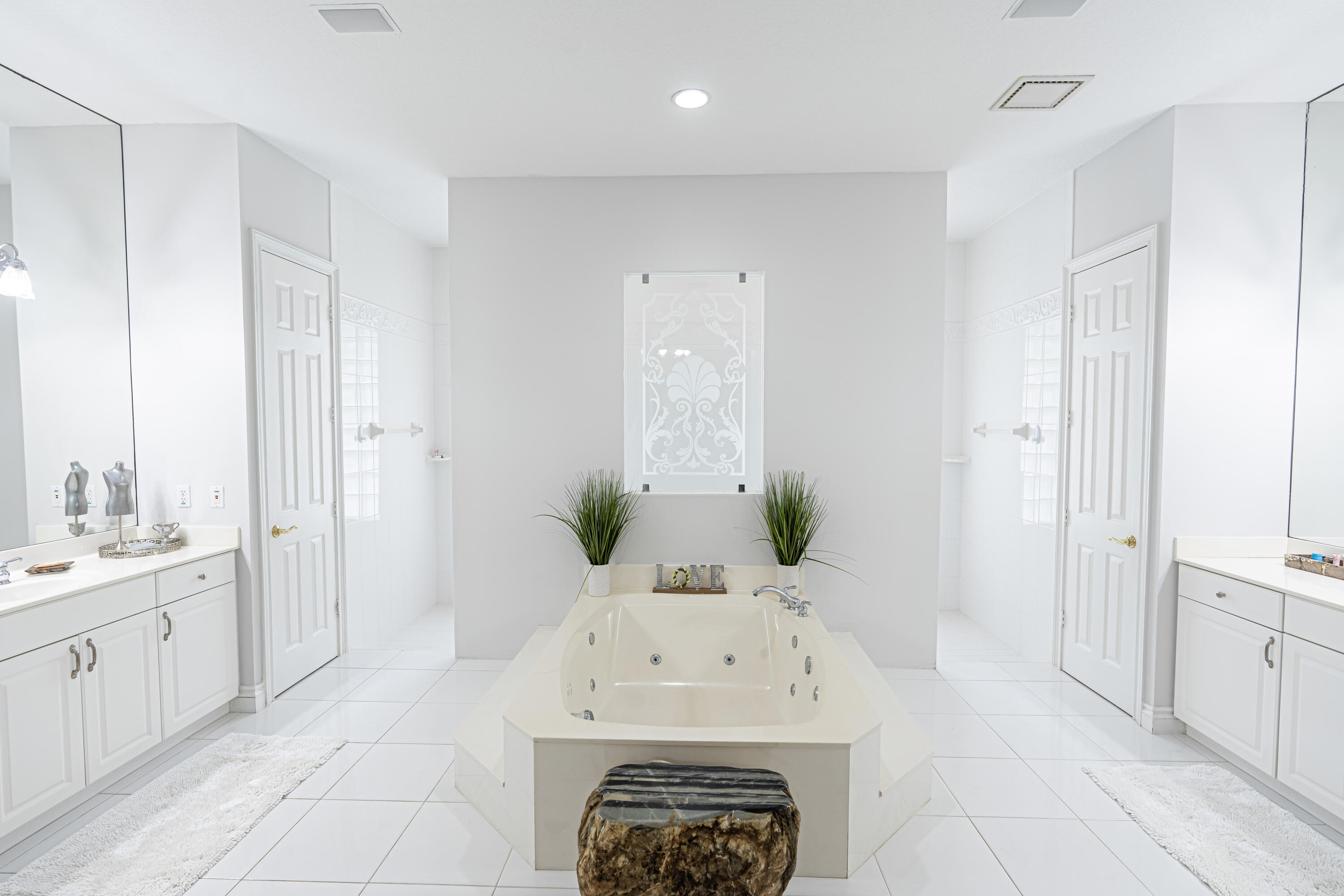 15350 Take Off Place Wellington, FL 33414 - Photo 21 of 44 a en suite bathroom with a sink and a mirror
