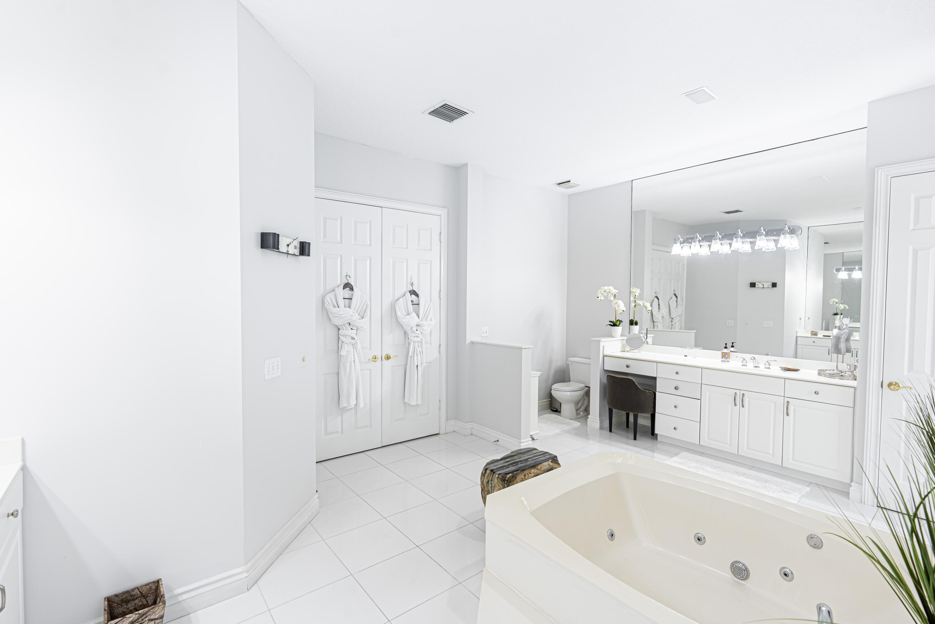 15350 Take Off Place Wellington, FL 33414 - Photo 23 of 44 a bathroom with a tub a sink and a large mirror