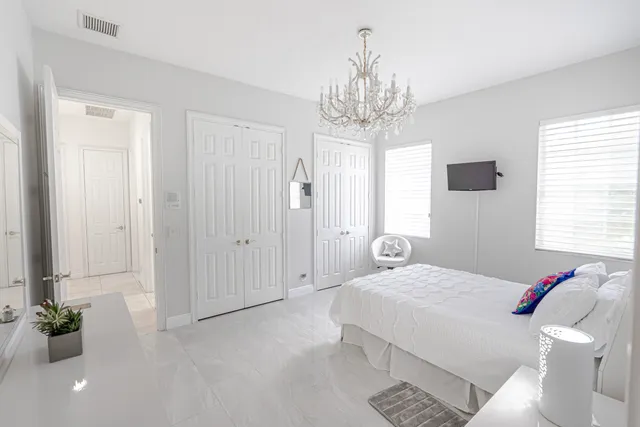 a bedroom with a chandelier and a chandelier