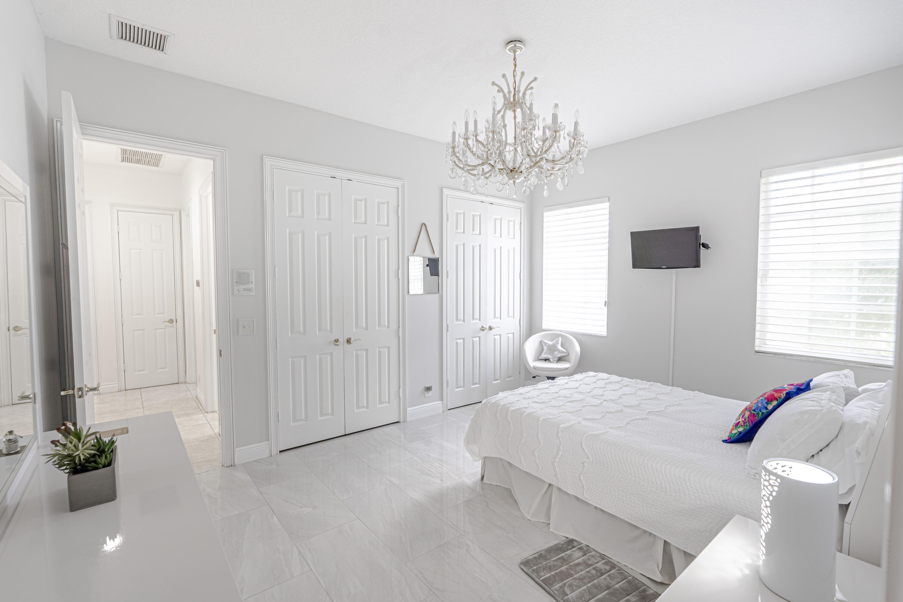 15350 Take Off Place Wellington, FL 33414 - Photo 28 of 44 a bedroom with a chandelier and a chandelier