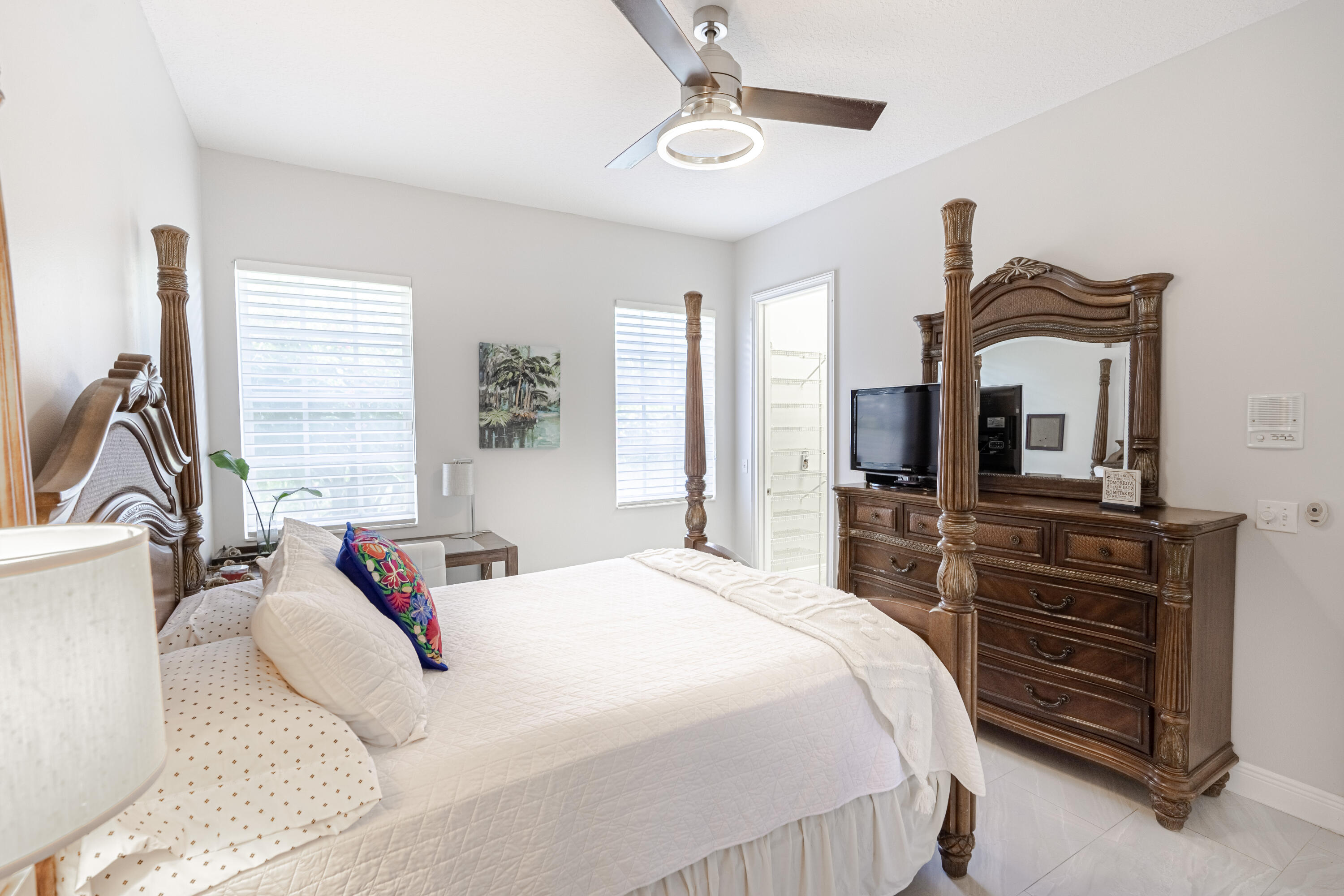 15350 Take Off Place Wellington, FL 33414 - Photo 29 of 44 a bedroom with a bed a dresser and flat screen tv