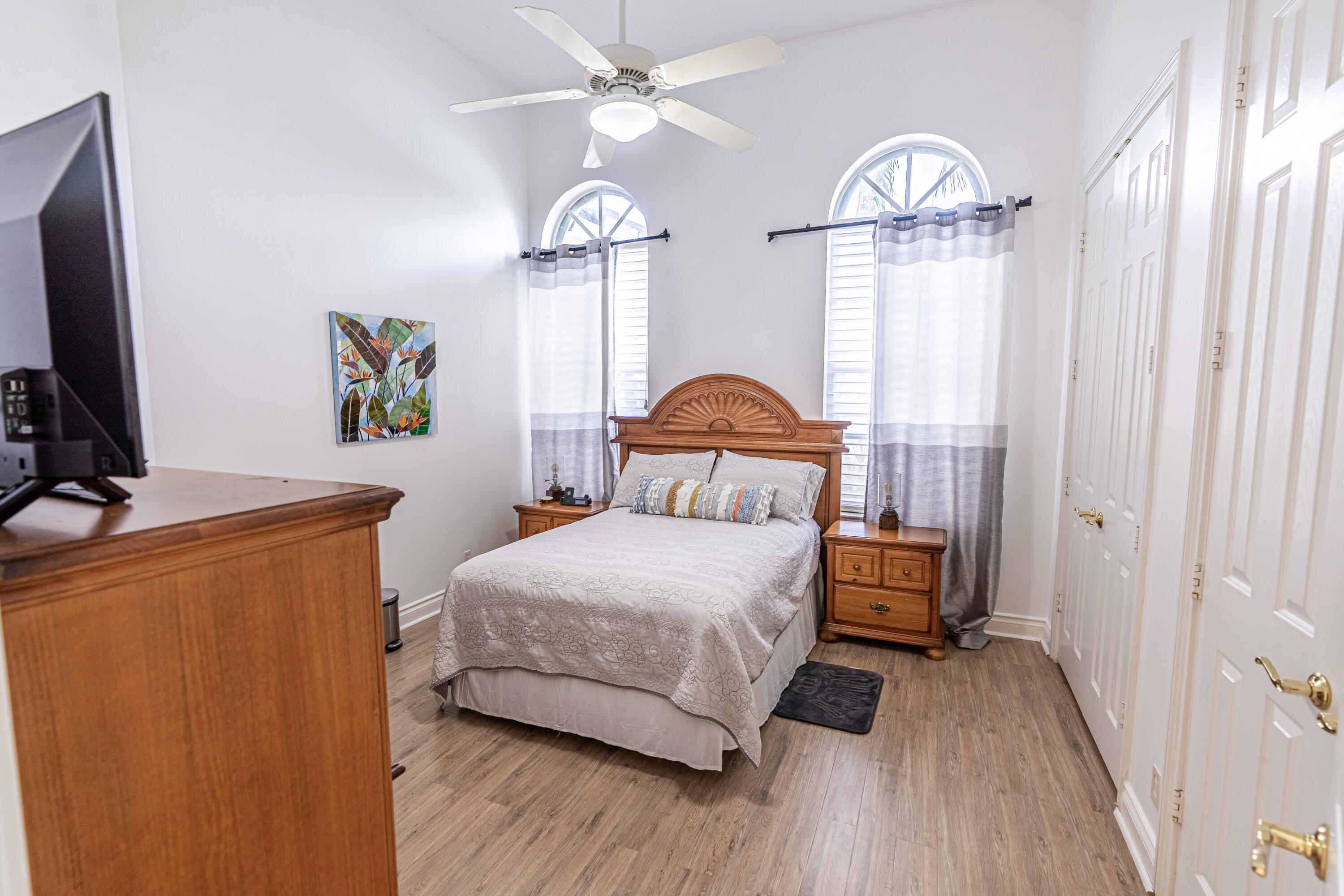 15350 Take Off Place Wellington, FL 33414 - Photo 31 of 44 a bedroom with a bed and a chandelier