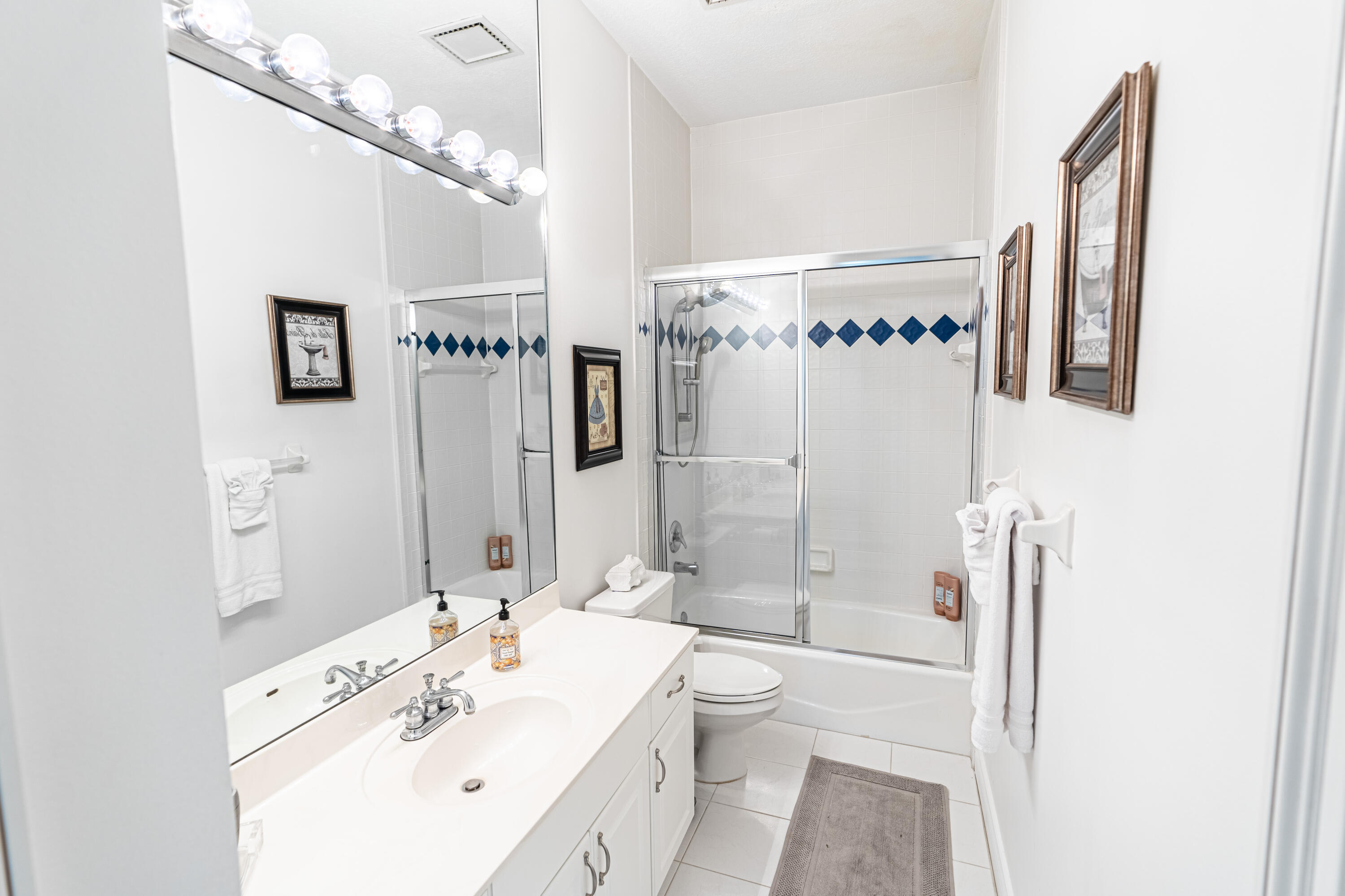 15350 Take Off Place Wellington, FL 33414 - Photo 32 of 44 a bathroom with a sink a toilet and shower